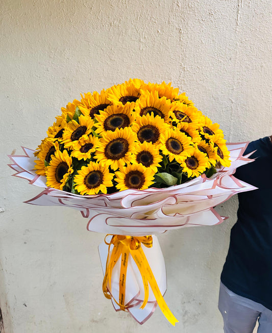 The Sunlit Bunch - 70 Sunflowers Hand Bouquet by BloomOnly who is a premium number 1 florist in pune that delivers same day